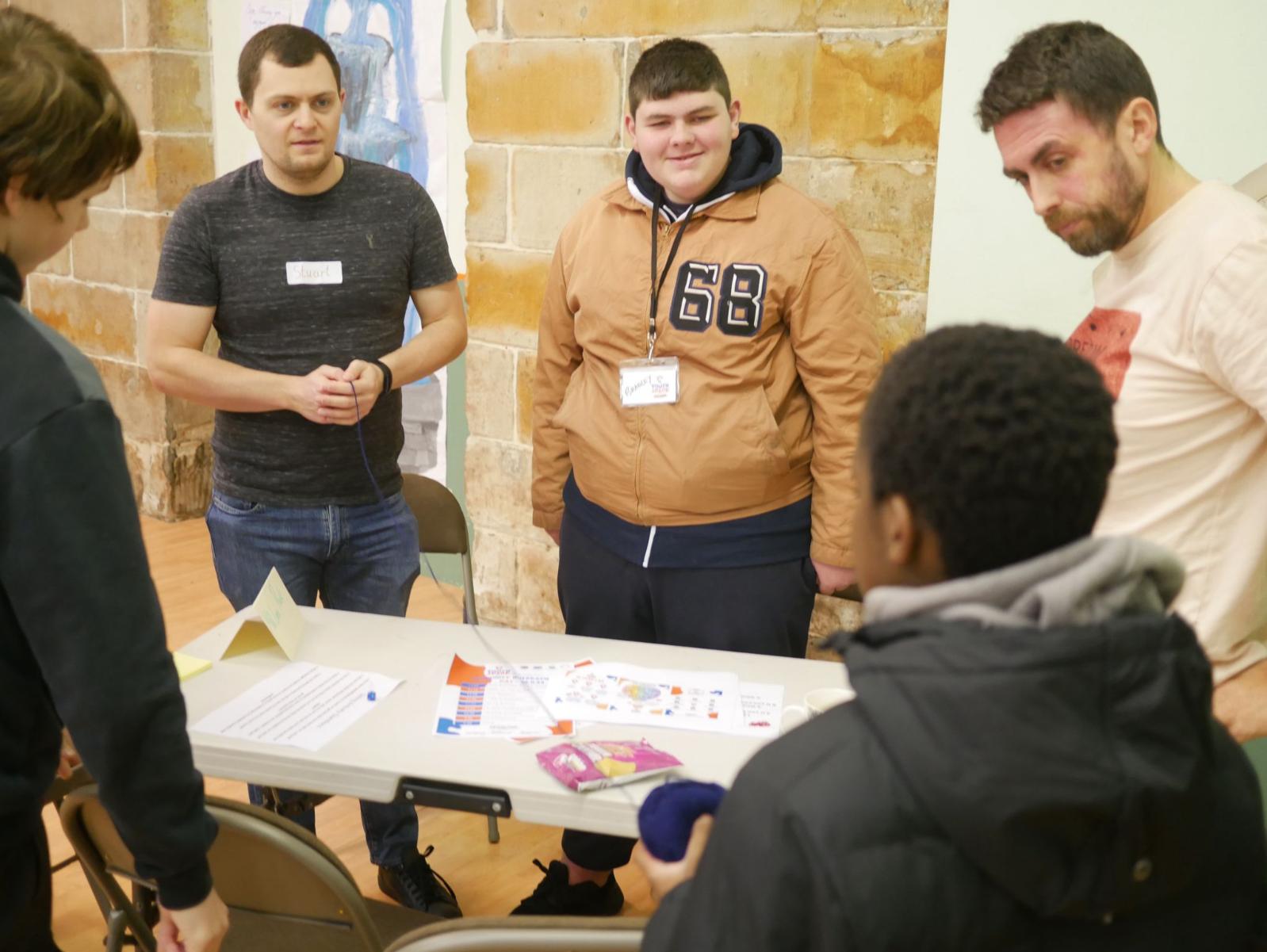 Young people and community members at our Community Outreach Day gathered around a table to discuss ideas on local green and blue spaces.