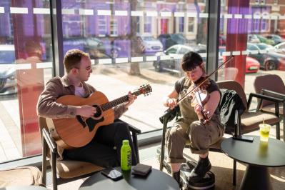 Image shows two musicians playing at the Staff Excellence Awards drinks reception