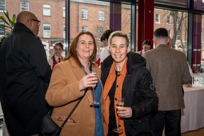 Image shows two staff members pictured at the Staff Excellence Awards drinks reception