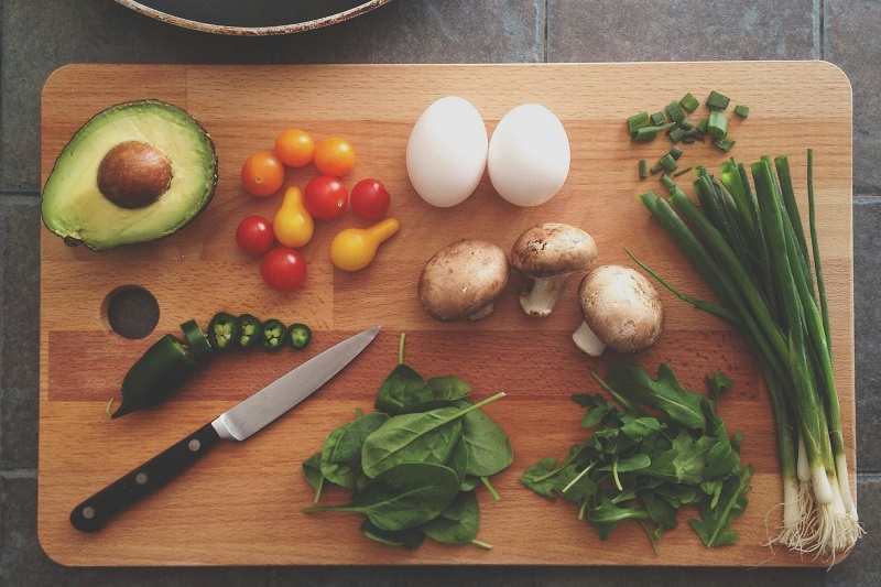 various healthy foods laid out on a chopping board - credit: Katie Smith, Unsplash