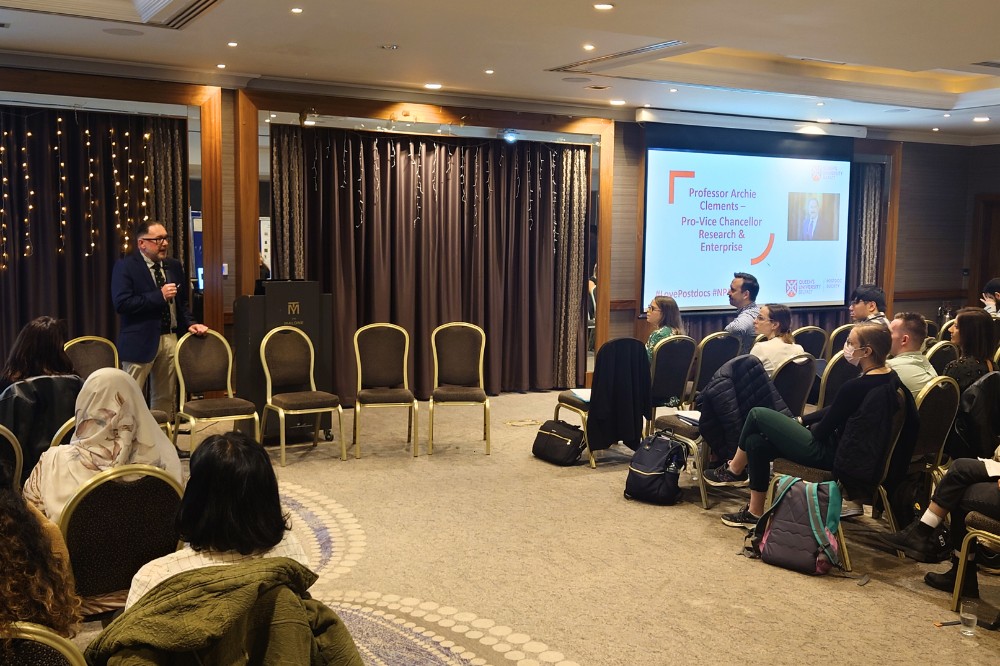 Professor Archie Clements speaking to a room full of postdoctoral researchers, Malone Hotel, September 2024