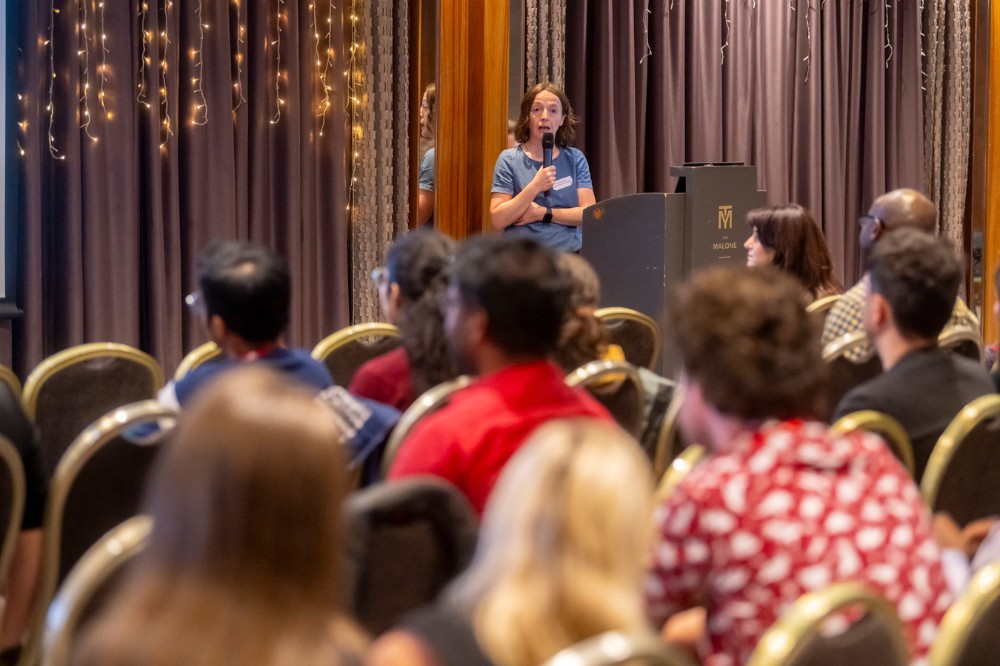 guest speaker presenting to a room full of postdoctoral researchers, Malone Hotel, September 2024